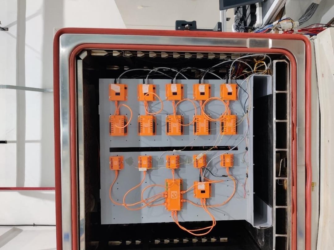 SwitchMon sensors and gateways on a test rack inside an SGS climate chamber